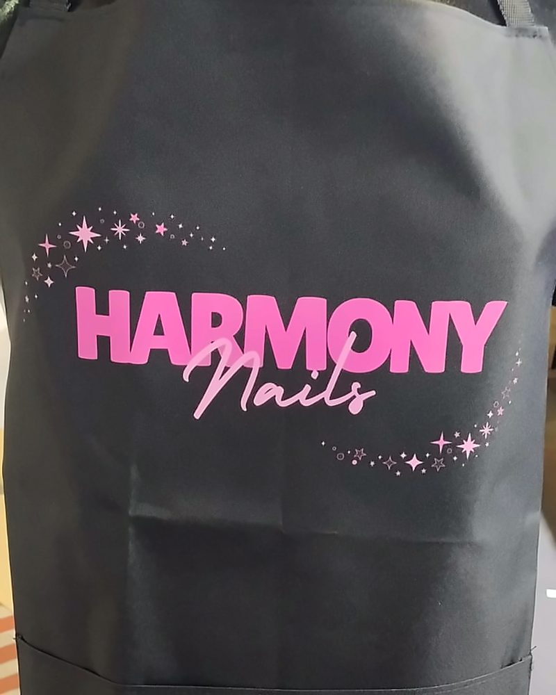Harmony Nails β pink print black apron