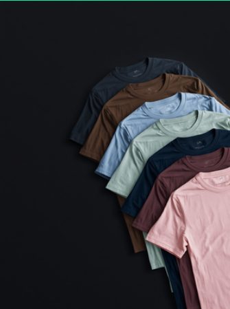 Stack of plain T-shirts in assorted colours ready for printing